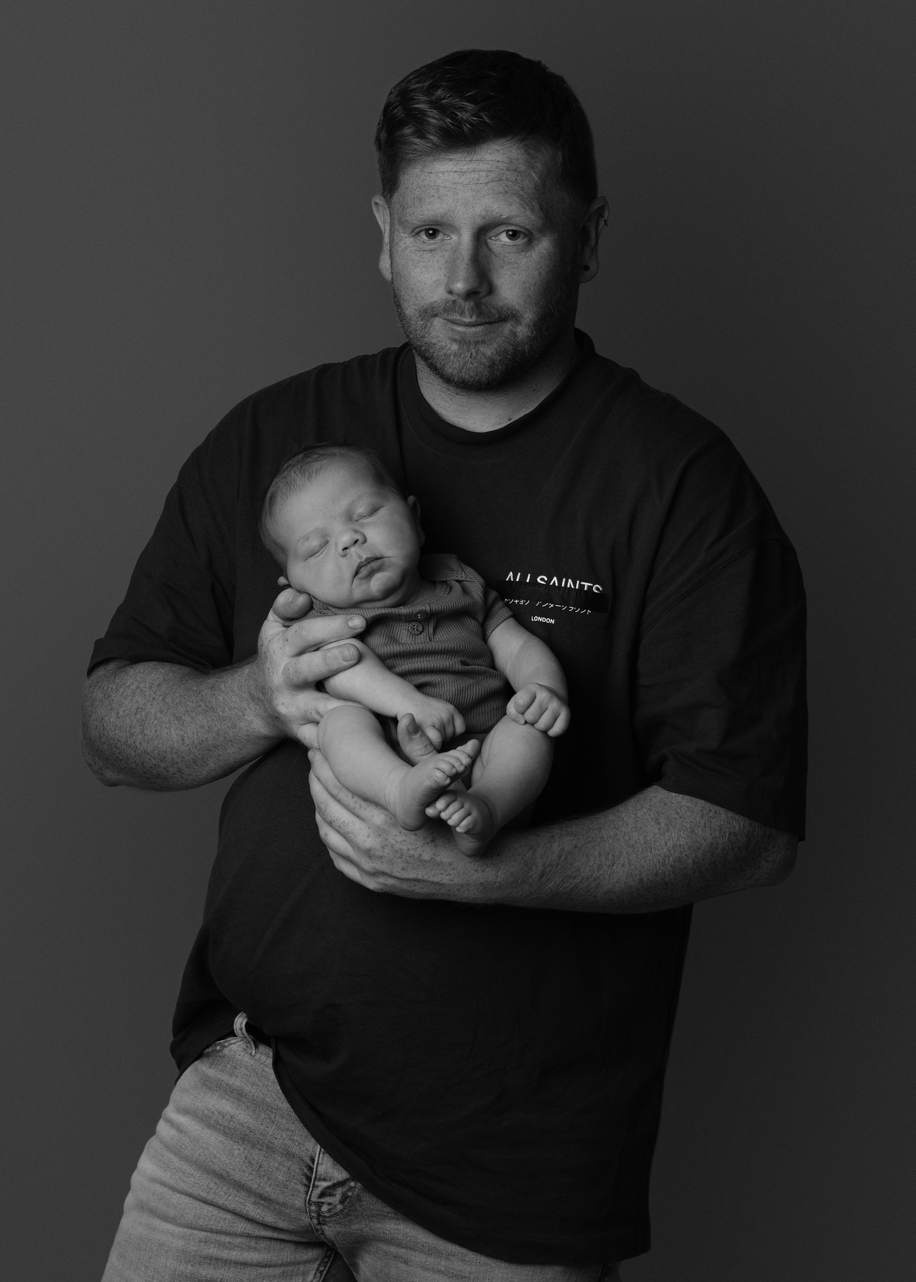 Black and white portrait of a father holding his baby girl
