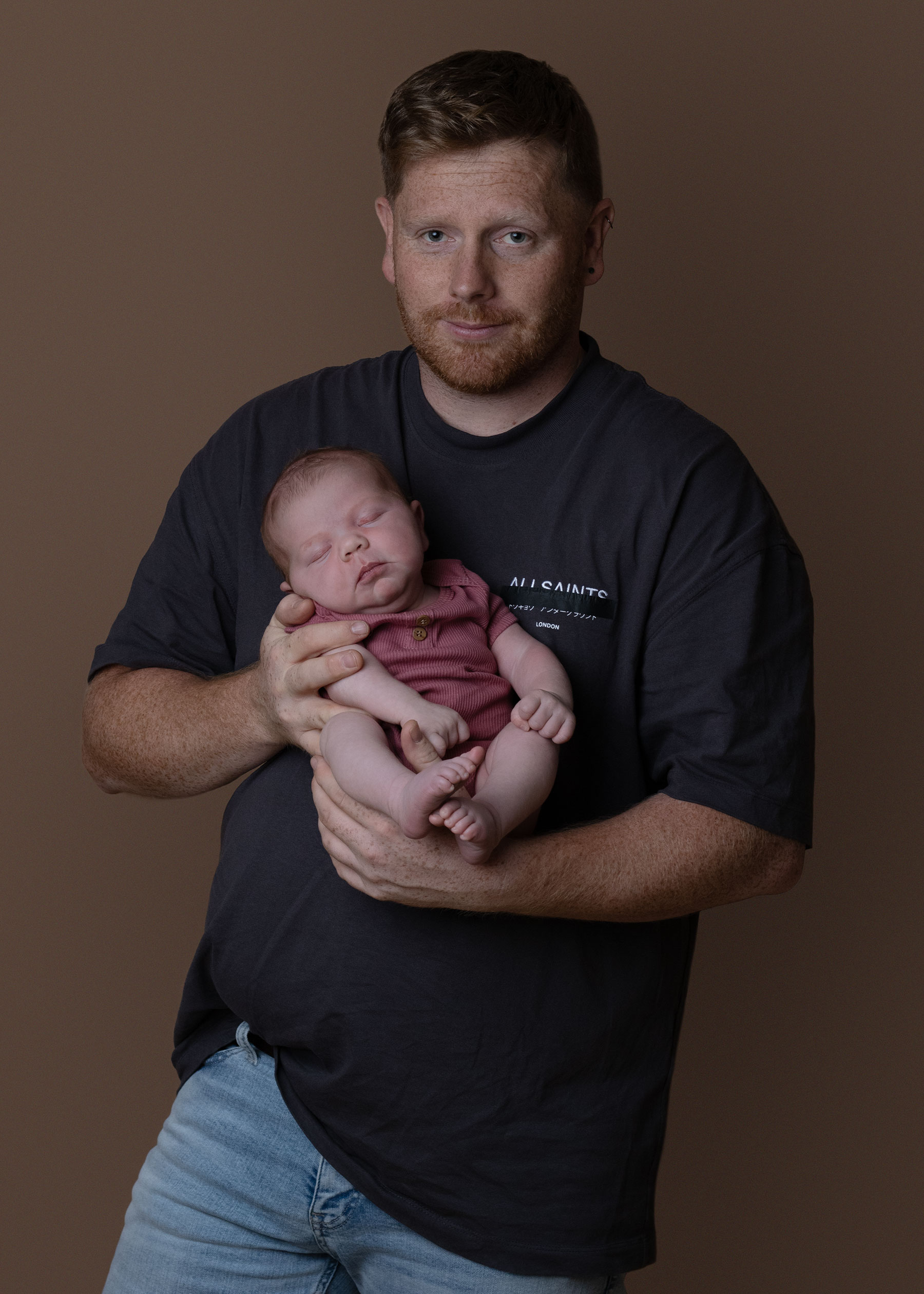 Father holding his baby girl during Ceredigion newborn session