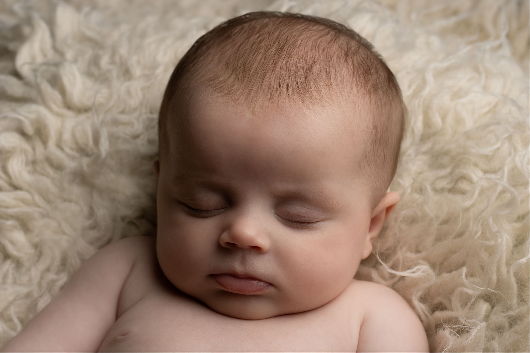 Close-up of a newborn baby's face during a newborn photoshoot