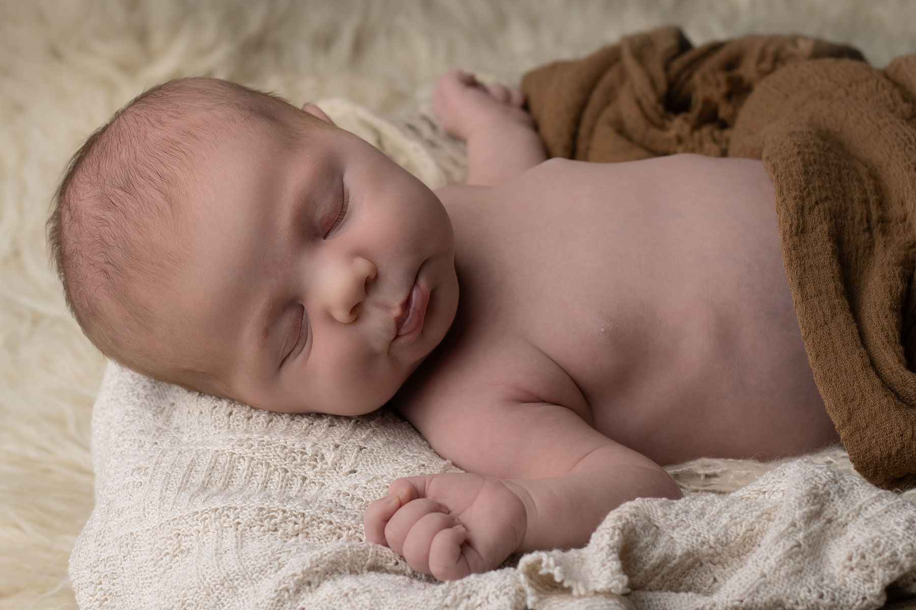 Newborn baby pouting with in-home newborn photographer in Ceredigion